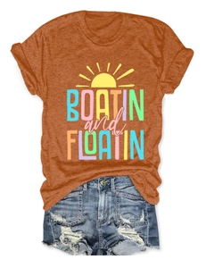 Detail of orange Boatin and Floatin t-shirt paired with distressed blue denim shorts