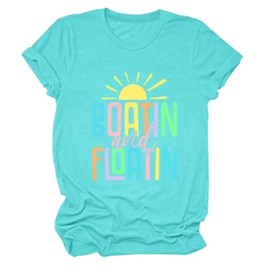 Close-up of Boatin and Floatin print on turquoise cotton t-shirt with sun graphic