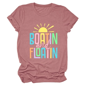 Flat lay of pink short sleeve t-shirt with Boatin and Floatin text and sun graphic
