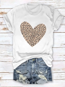 Flat lay of white T-shirt with leopard print heart paired with distressed denim shorts