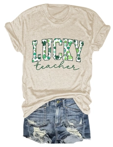 Flat lay of an oat-colored St. Patrick's Day T-shirt and ripped denim shorts outfit