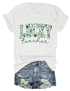 Flat lay of white Lucky Teacher t-shirt with clover print and ripped denim shorts
