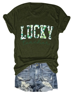 Flat lay of a green LUCKY teacher T-shirt paired with distressed blue denim shorts