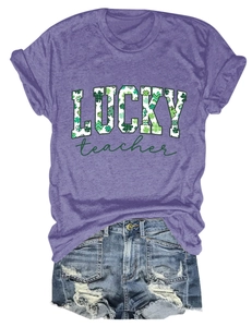Detail of purple Lucky Teacher t-shirt with clover pattern and distressed denim shorts