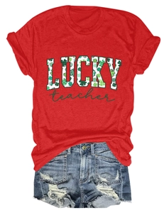 Flat lay of a red St. Patrick's Day Lucky Teacher t-shirt and ripped denim shorts set