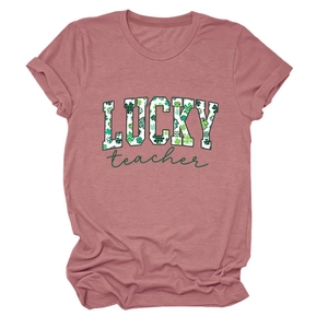 Detail of LUCKY teacher text with green clover pattern on a pink cotton short sleeve t-shirt