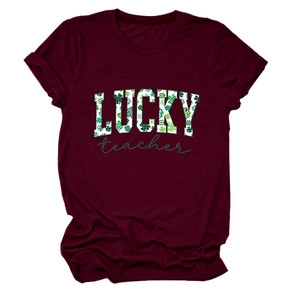 Close-up of the wine red fabric texture and St. Patrick's Day Lucky Teacher print on the tee