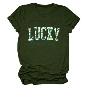 Flat lay of a green crewneck T-shirt with Lucky Teacher shamrock print for St. Patrick's Day