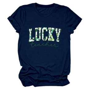 Detail of Lucky Teacher text with green shamrocks on navy blue cotton t-shirt