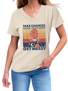 Detail of V-neck T-shirt showing retro sunset print and Take Chances Make Mistakes slogan
