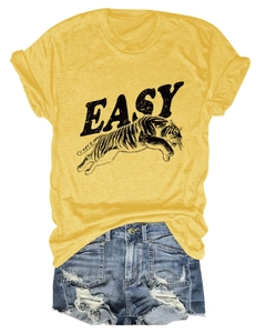 Detail of tiger and EASY text print on yellow T-shirt with distressed denim shorts