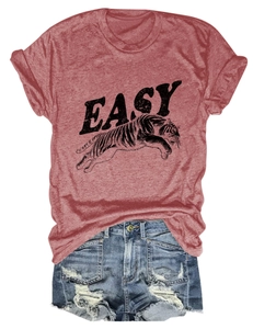 Detail of rust red t-shirt with tiger print and distressed denim shorts on white background