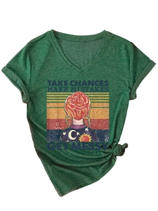 Detail of V-neck T-shirt in dark green with colorful vintage graphic and knot hem