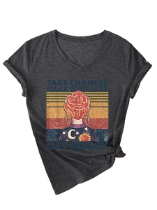 Detail of V-neck dark grey t-shirt with retro Frizzle illustration and knot detail