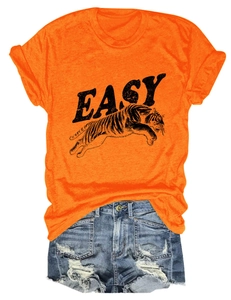 Flat lay of bright orange tiger print T-shirt and ripped denim shorts outfit