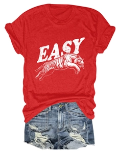 Detailed flat lay of red round neck T-shirt with white tiger print and ripped denim shorts
