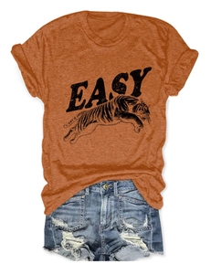 Flat lay of caramel T-shirt with tiger print and EASY text paired with ripped denim shorts