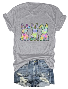 Detail of grey t-shirt featuring three colorful rainbow rabbits and distressed denim shorts