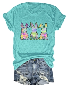 Flat lay of blue T-shirt featuring three colorful graffiti rabbits and ripped denim shorts