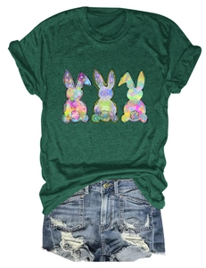 Detail view of colorful rabbit silhouettes printed on a dark green cotton t-shirt