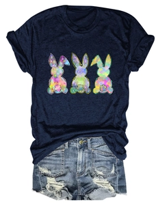 Flat lay of navy cotton T-shirt with three colorful bunnies and ripped denim shorts