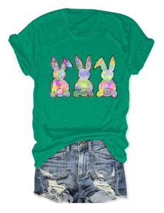 Detail of three colorful patchwork rabbits printed on a casual green cotton T-shirt