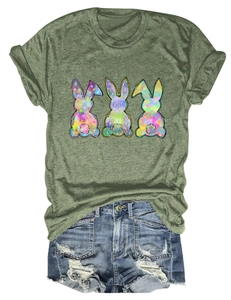 Close-up of olive green t-shirt with three colorful Easter bunny silhouettes and denim shorts