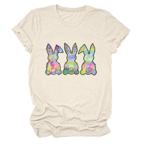 Close-up of colorful tie-dye bunny prints on a cream round neck short sleeve T-shirt