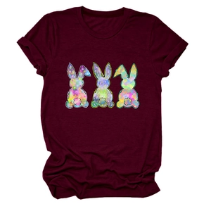Close-up of three colorful graffiti rabbit prints on a burgundy cotton T-shirt