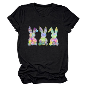Detail of three colorful tie-dye bunny silhouettes printed on a black crew neck T-shirt