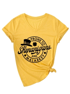 Detail of yellow V-neck t-shirt with front knot and St. Patrick's Day themed graphic