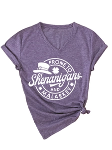 Detail of purple V-neck t-shirt featuring shenanigans print and front hem knot design