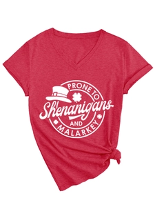 Detail of red V-neck T-shirt with St. Patrick's Day logo and stylish hem knot design