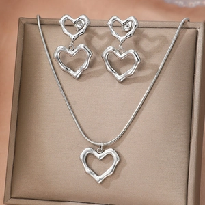 Parure de bijoux cœur en argent avec collier et boucles d'oreilles dans un écrin brun