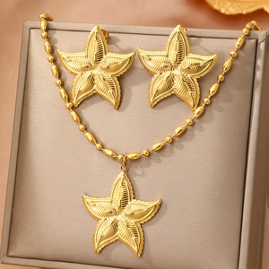 Starfish jewelry set with gold necklace and matching stud earrings on display box