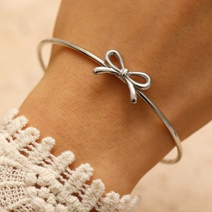 Elegant silver bow open bracelet for women with minimalist adjustable bangle design
