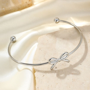 Elegant silver bow open bangle bracelet for women with minimalist adjustable metal design