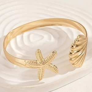 Elegant gold ocean starfish and seashell open bangle in a nautical beach style