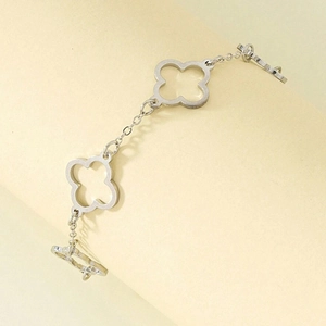 S-shaped silver stainless steel bracelet featuring hollow clover charms and an OT clasp