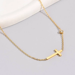 Minimalist gold titanium steel cross necklace with a small zircon on a delicate link chain