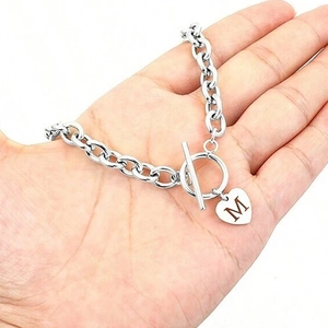 Silver stainless steel OT clasp bracelet with heart pendant featuring engraved letter M