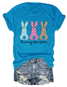 Mise à plat d'un T-shirt bleu vif avec trois silhouettes de lapins à motifs variés