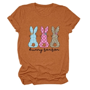 Gros plan sur un t-shirt caramel avec trois silhouettes de lapin et le texte Bunny Season