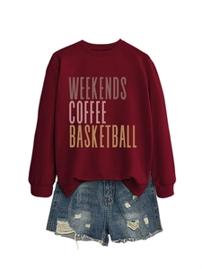 Flat lay of burgundy crewneck sweatshirt with coffee print and ripped denim shorts