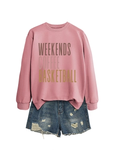 Flat lay of pink sweatshirt with 'WEEKENDS COFFEE' text and distressed denim shorts