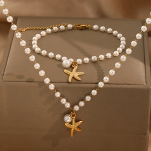 Exquisite 18K gold plated pearl jewelry set with starfish pendants on a silk background