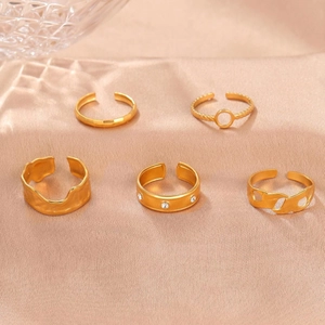 Lot de 5 bagues en acier titane doré avec motifs de vagues et strass sur fond de satin