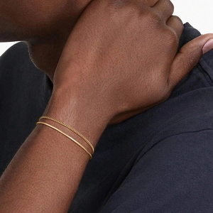 Double-layered gold stainless steel bracelet with Cuban and snake chains on male model