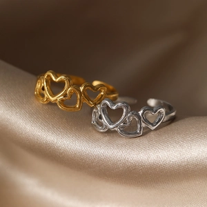 Vintage stainless steel open heart ring in gold and silver finish on silk fabric