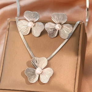 Elegant stainless steel necklace and earring set with floral motifs and pearls